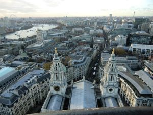 Views over the city of the greyish London, with the river Thames to the left, from St. Paul's Cathedral.